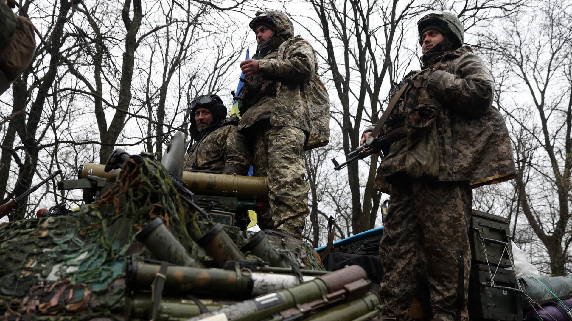 Ukrainian soldiers stand on their armored personnel carrier, not far from the front-line with Russian troops, in the Kharkiv region on April 18, 2022. Russia-aligned actors began pre-positioning for the invasion of Ukraine as early as March 2021, according to a Microsoft report released yesterday.