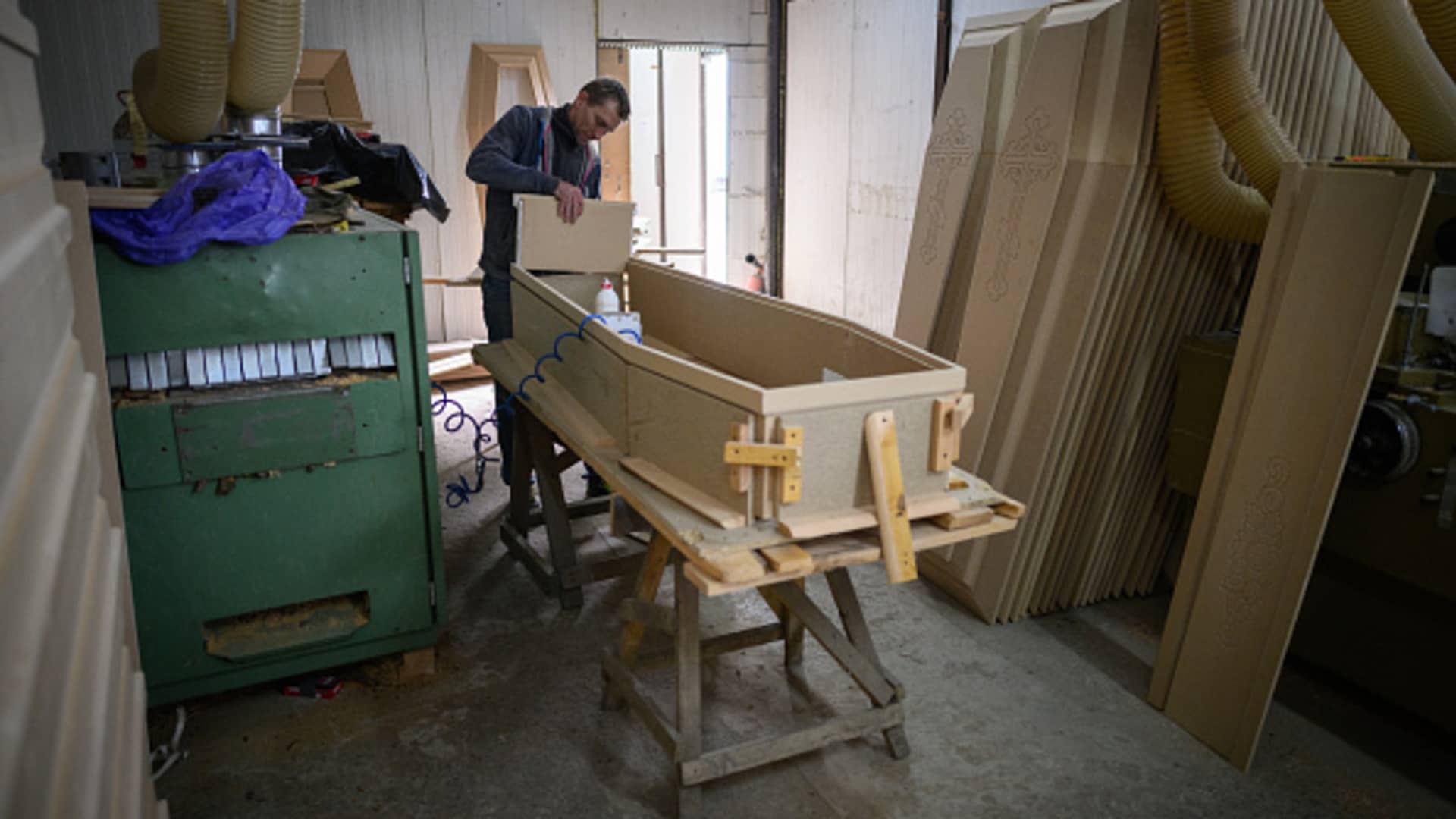Craftsman Ruslan Petryshyn constructs the framework of a new coffin at a coffin workshop on April 28, 2022 in Rava-Ruska, Ukraine.