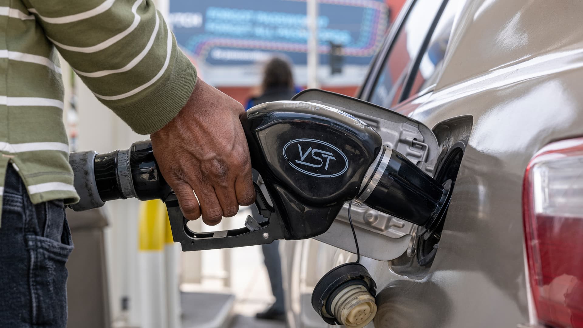 A customer holds a fuel nozzle at a gas station in San Francisco, California, U.S., on Wednesday, April 27, 2022. California is set for an automatic increase in its fuel tax July 1 after Governors Gavin Newsom failed to convince lawmakers to pause the hike, part of his plan to bring relief to residents in the state with the most expensive gasoline.
