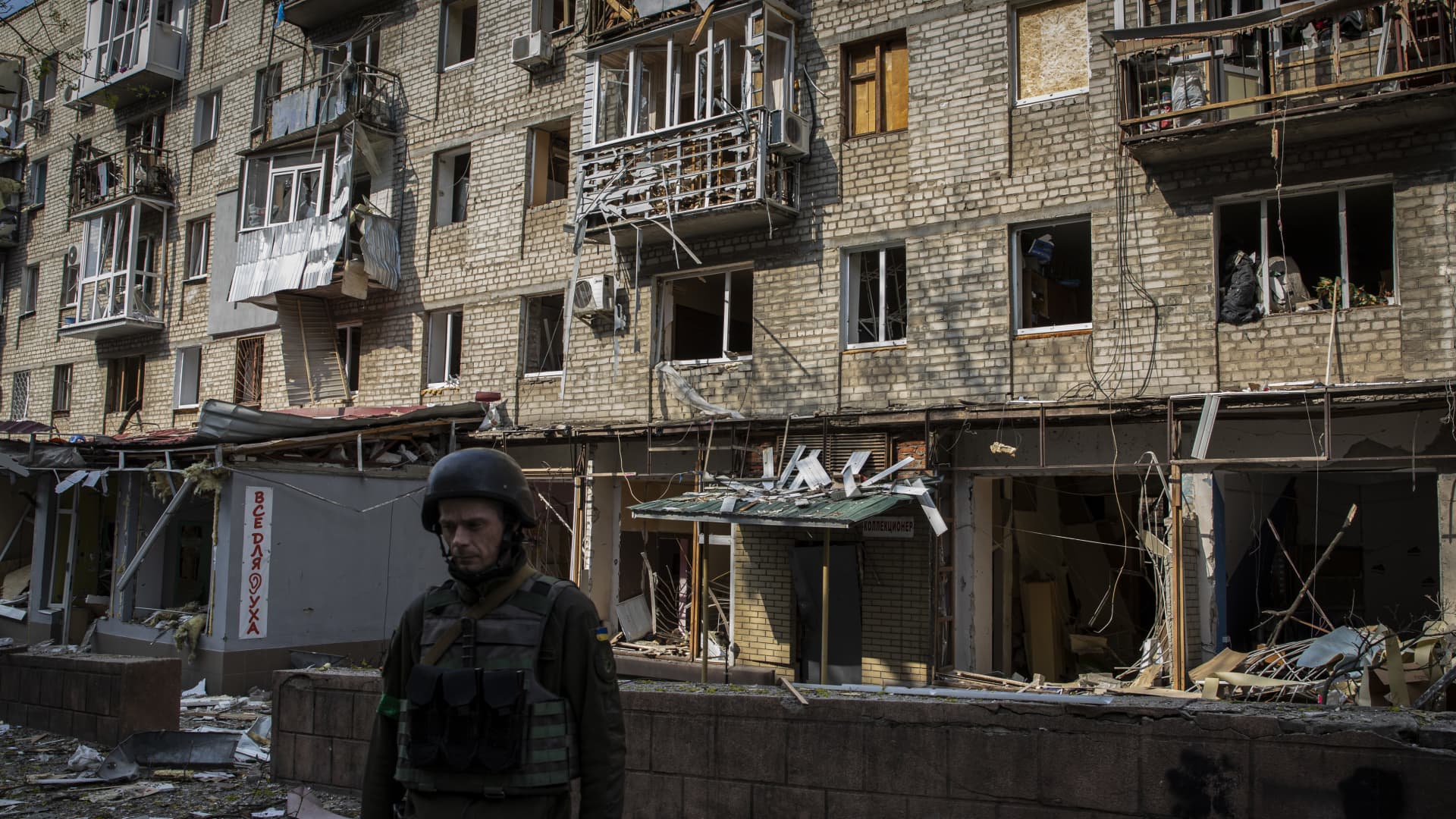 A Ukrainian soldier in front of a residential building destroyed by a Russian artillery strike in Kharkiv, Ukraine. Russia is likely to intensify ongoing deportations of Ukrainians, said the U.S. ambassador to the Organization for Security and Cooperation in Europe.