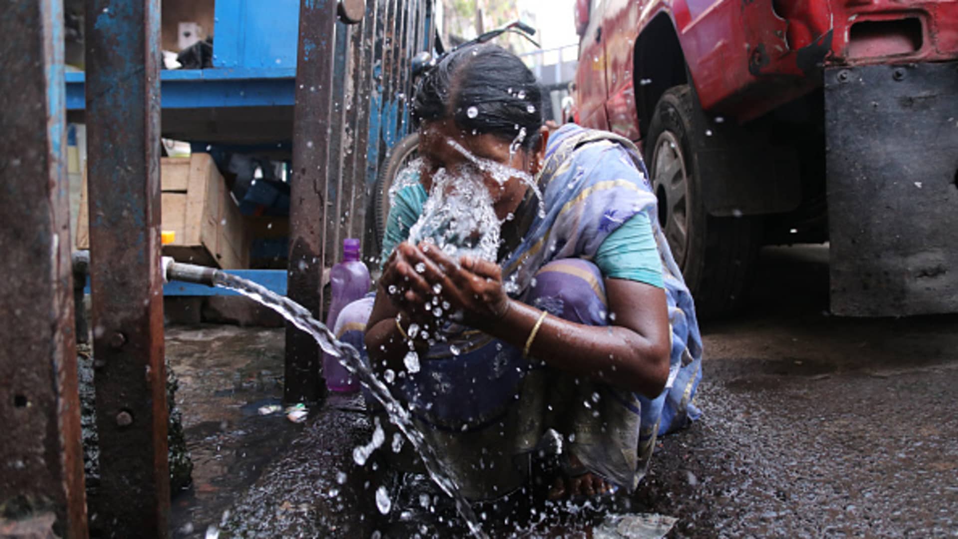 A old age women puts water on his face to get relief from extreme heat during hot weather, Kolkata Maximum Temperature In Kolkata Likely To Touch 40 Degrees on April 26,2022.