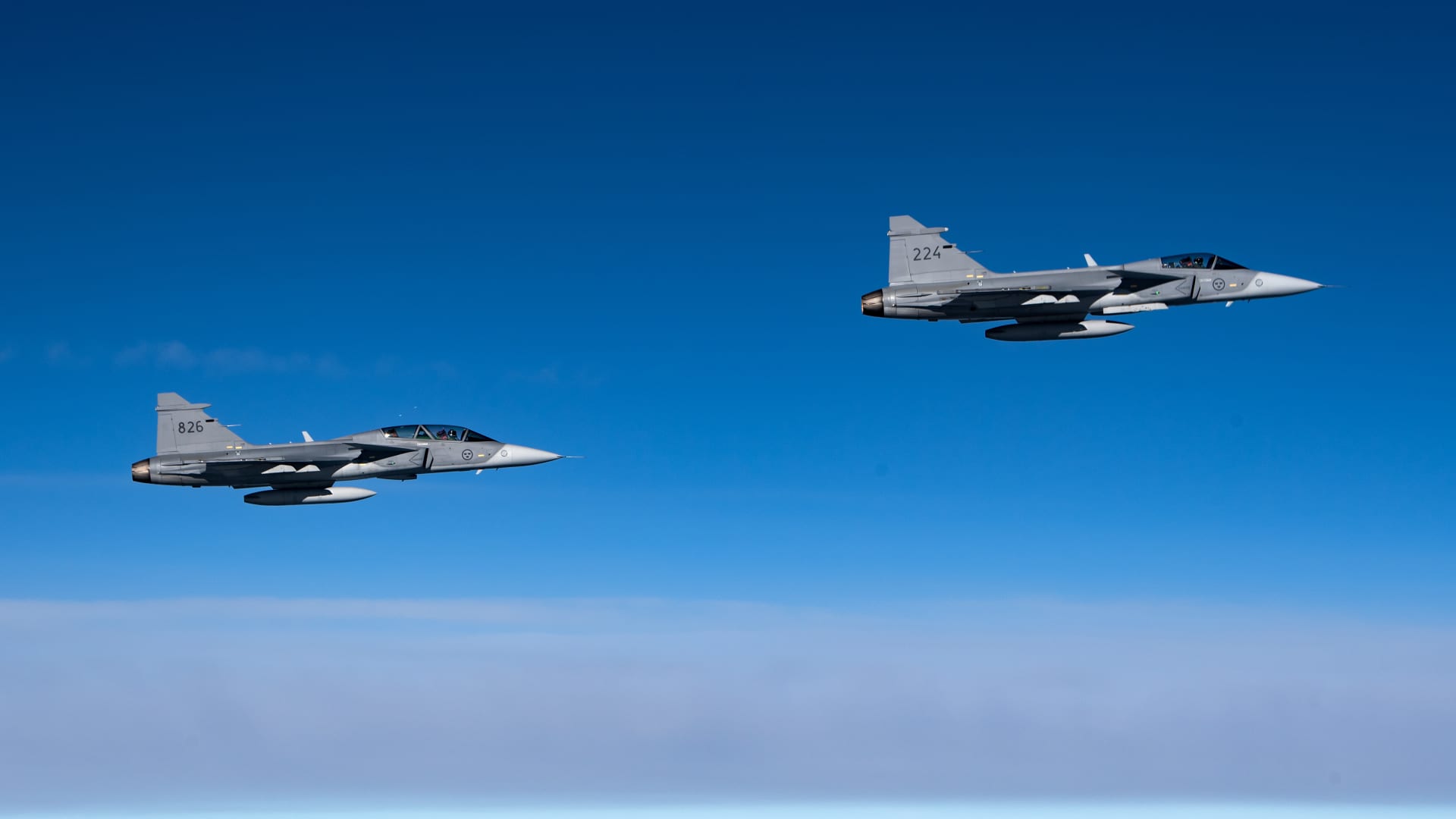 Two Swedish Air Force jets fly over their home territory in 2021.