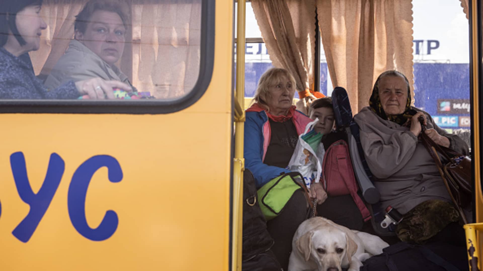 Women from the frontline town of Orikhiv wait on a bus after arriving at an evacuation point for people fleeing Mariupol, Melitopol and the surrounding towns under Russian control on May 02, 2022 in Zaporizhzhia, Ukraine.