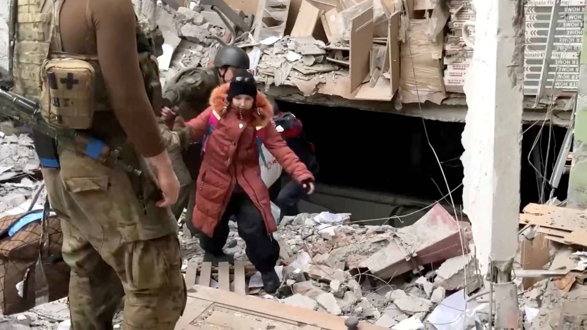 A child emerges from the Azovstal steel plant during UN-led evacuations, after nearly two months of siege warfare on the city by Russia during its invasion, in Mariupol, Ukraine in this still image from handout video released May 1, 2022. 