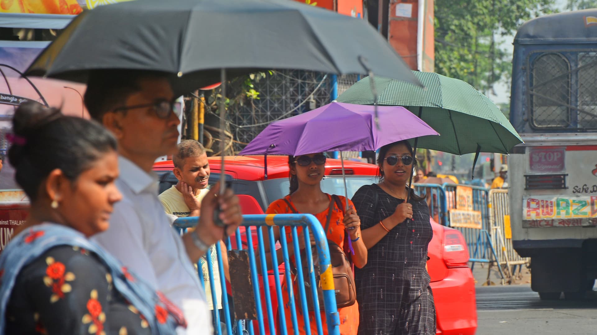 People outside holding an umbrella during hot summer day in Kolkata, West Bengal, India on April 26. The temperature in Kolkata was around 40°c.