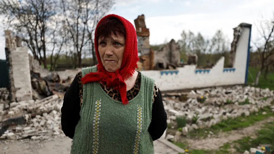 Lyubov Lenko, 61, stands at the yard of her house that according to her was destroyed by shelling, amid the Russian invasion of Ukraine in Budy, Chernihiv region, Ukraine May 3, 2022. REUTERS/Zohra Bensemra