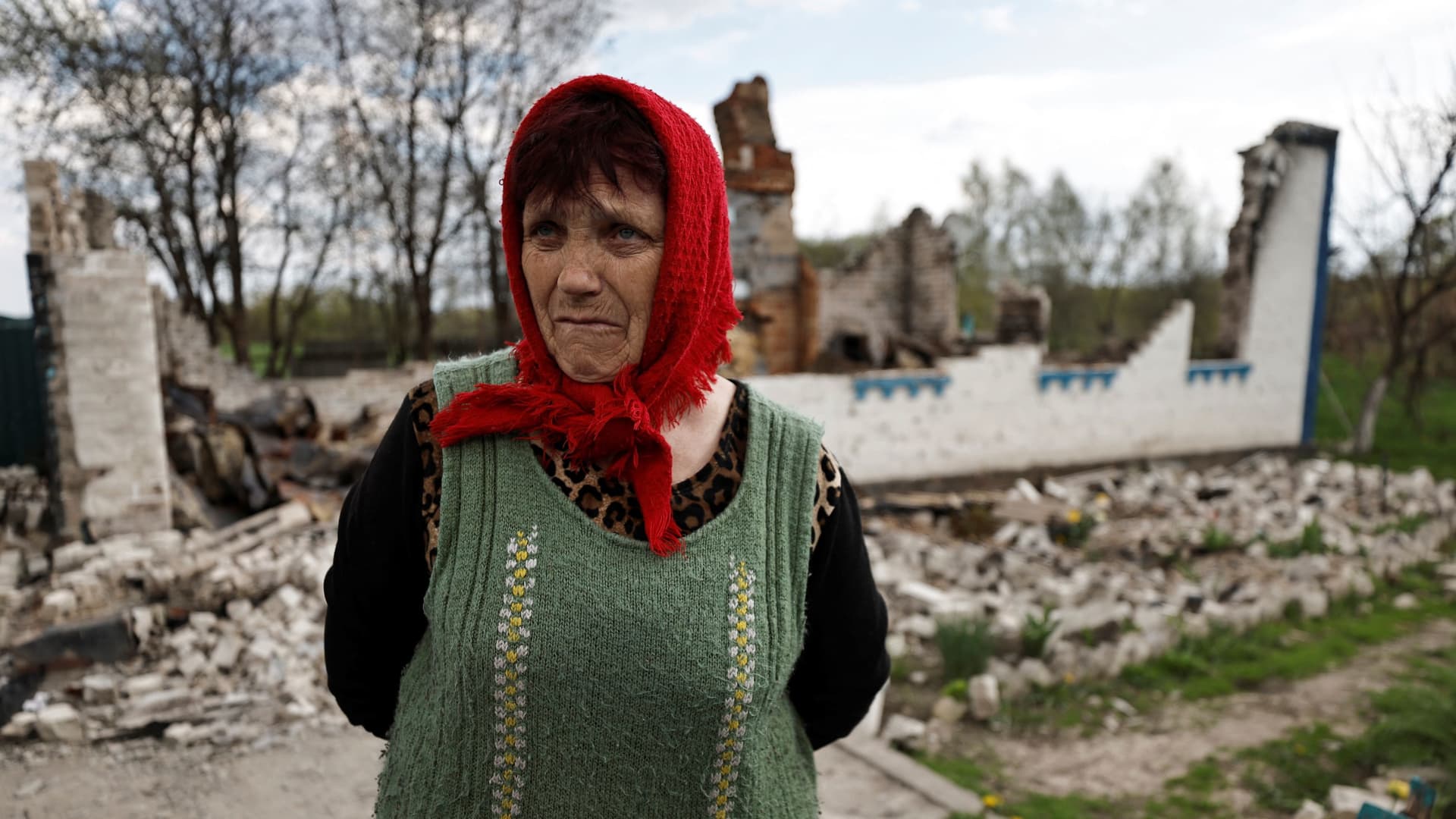 Lyubov Lenko, 61, stands at the yard of her house that according to her was destroyed by shelling, amid the Russian invasion of Ukraine in Budy, Chernihiv region, Ukraine May 3, 2022. 