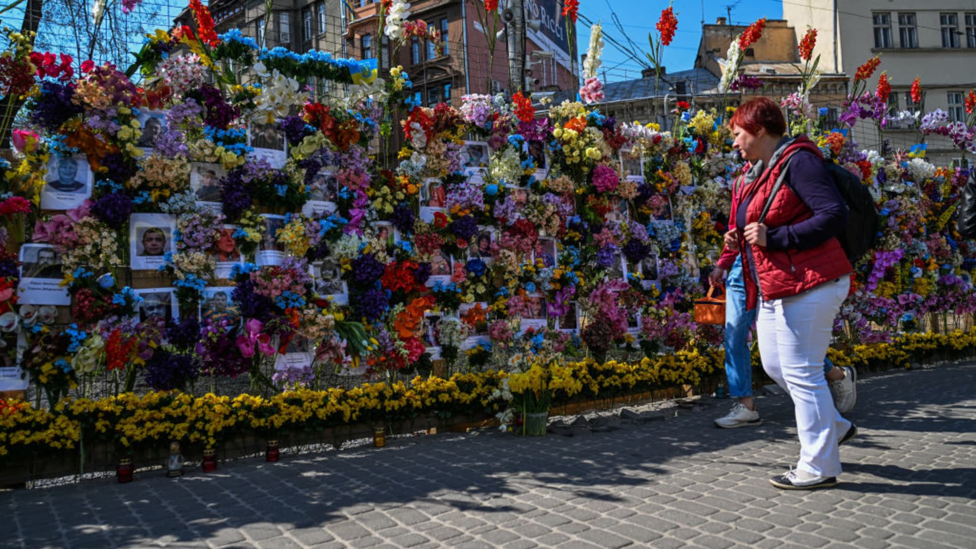 People walk past flower memorial wall in memory of the victims of Russia's attacks in Lviv, Ukraine on May 03, 2022. 