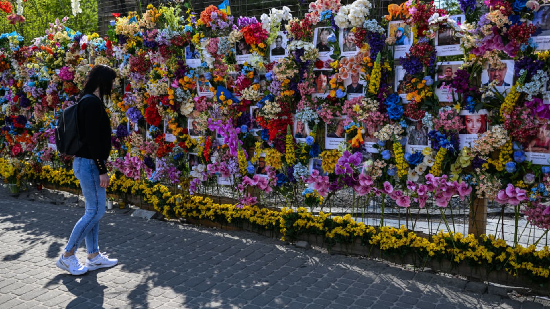 A woman views the flower memorial wall in memory of the victims of Russia's attacks in Lviv, Ukraine on May 03, 2022. 