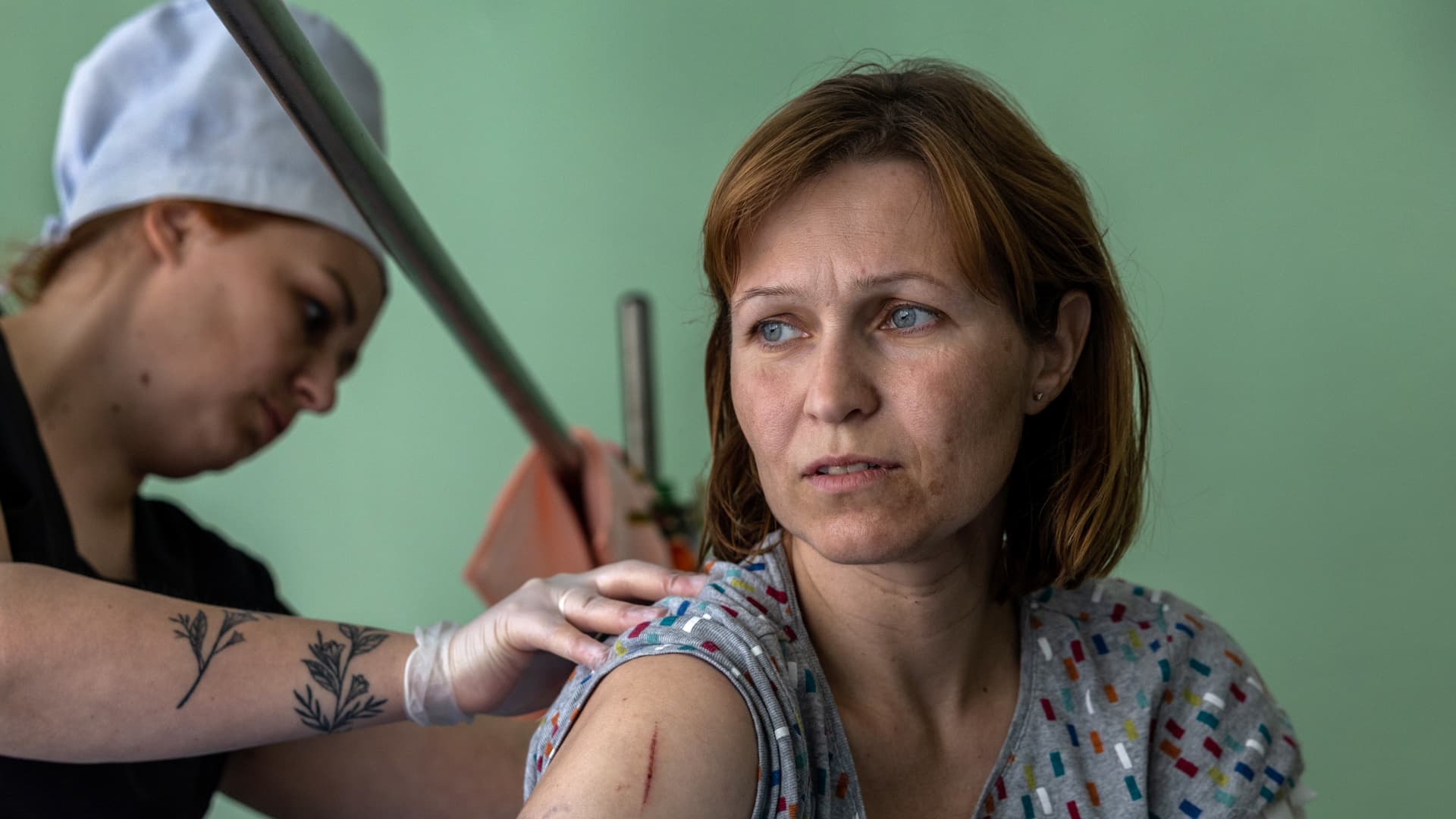 A nurse checks the wounds of Ponomareva Natalia Sergiivna, 51, only three days after her family's home was shelled by Russian forces in their frontline village of Vysokopilla in the Kherson region of southern Ukraine on May 05, 2022 in Kryvyi Rih, Ukraine.