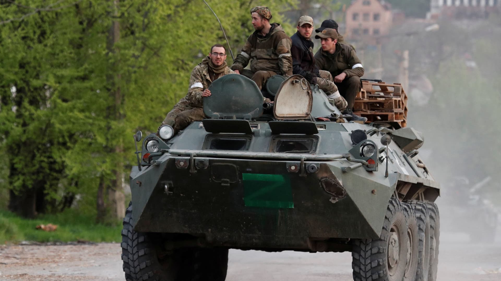 Service members of pro-Russian troops ride an armored personnel carrier during fighting in Ukraine-Russia conflict near the Azovstal steel plant in the southern port city of Mariupol, Ukraine May 5, 2022.
