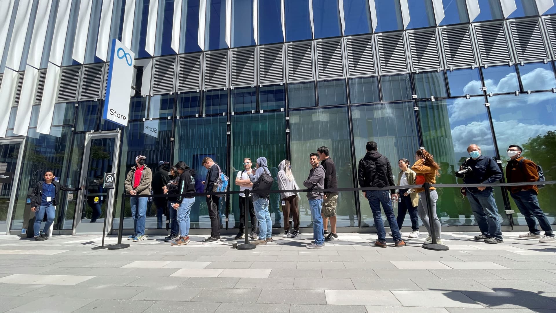 Customers wait in line outside the new Meta retail store on its opening day in Burlingame, California, May 9, 2022.