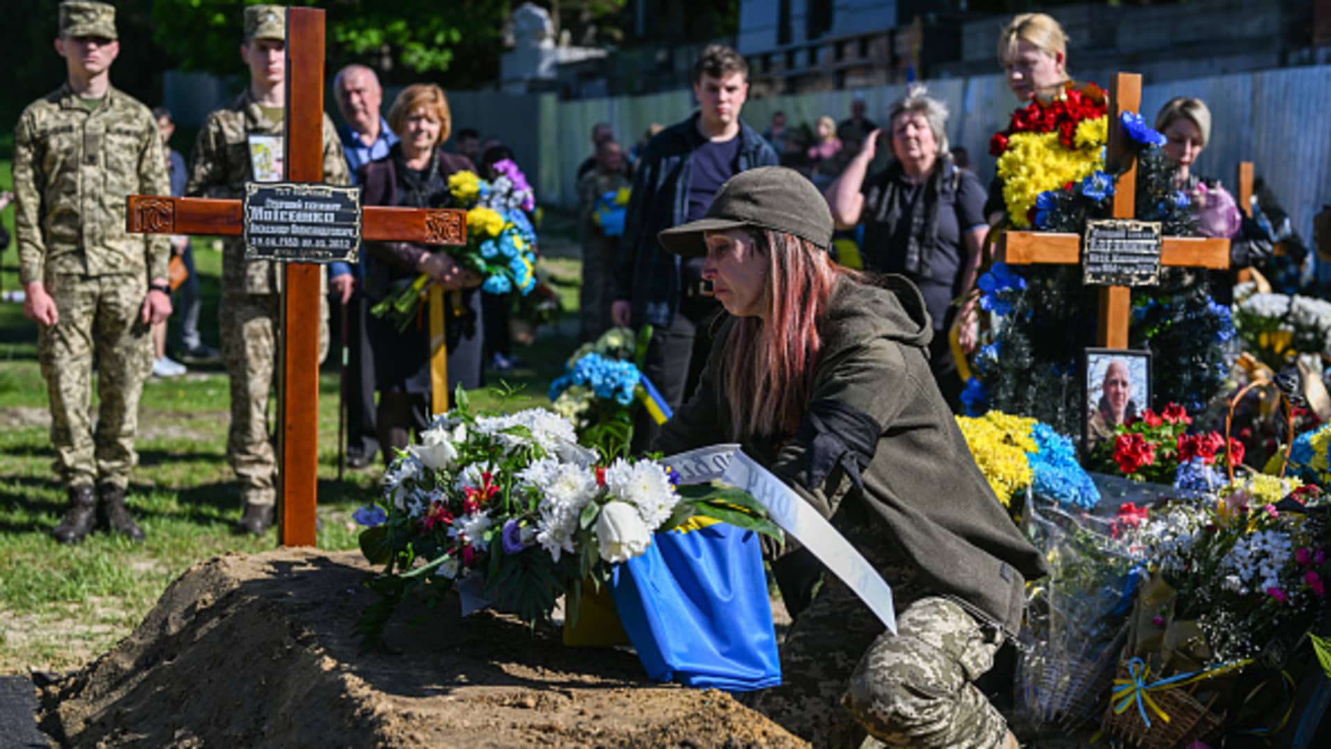 The wife of Olexandr Moisenko, age 42 who fell during the fights against Russia lays flowers on his grave at the Field of Mars of Lychakiv cemetery in Lviv, Ukraine on May 10, 2022.