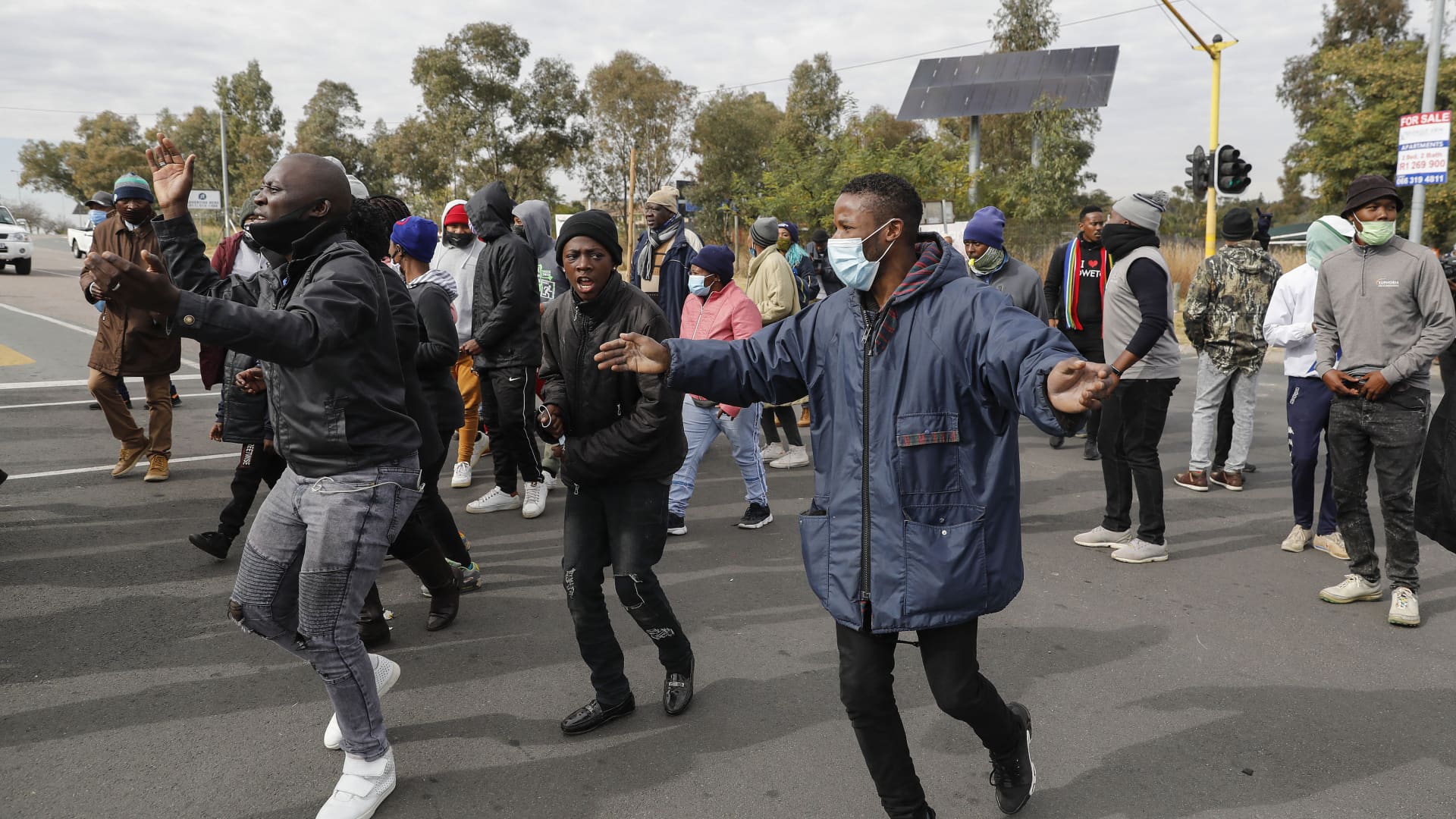 JOHANNESBURG, South Africa: Soweto residents picket near the entrance to state entity Eskom Offices at Megawatt Park in Midrand, near Johannesburg, on June 9, 2021 due to the ongoing electricity disruptions. Eskom, on June 9, 2021 announced it will implement nationwide power cuts due to rising consumption as the cold weather sets in and breakdowns at two power plants.
