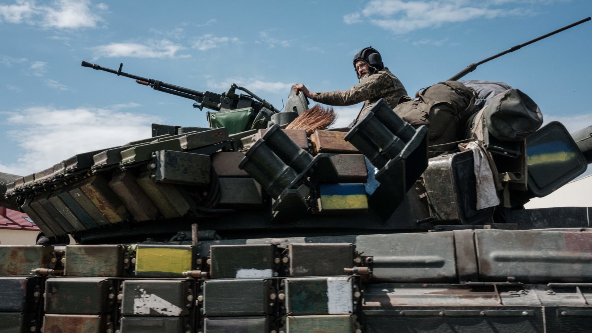 A Ukrainian soldier sits on a tank carryied by a transporter near Bakhmut, eastern Ukraine, on May 12, 2022, amid the Russian invasion of Ukraine.