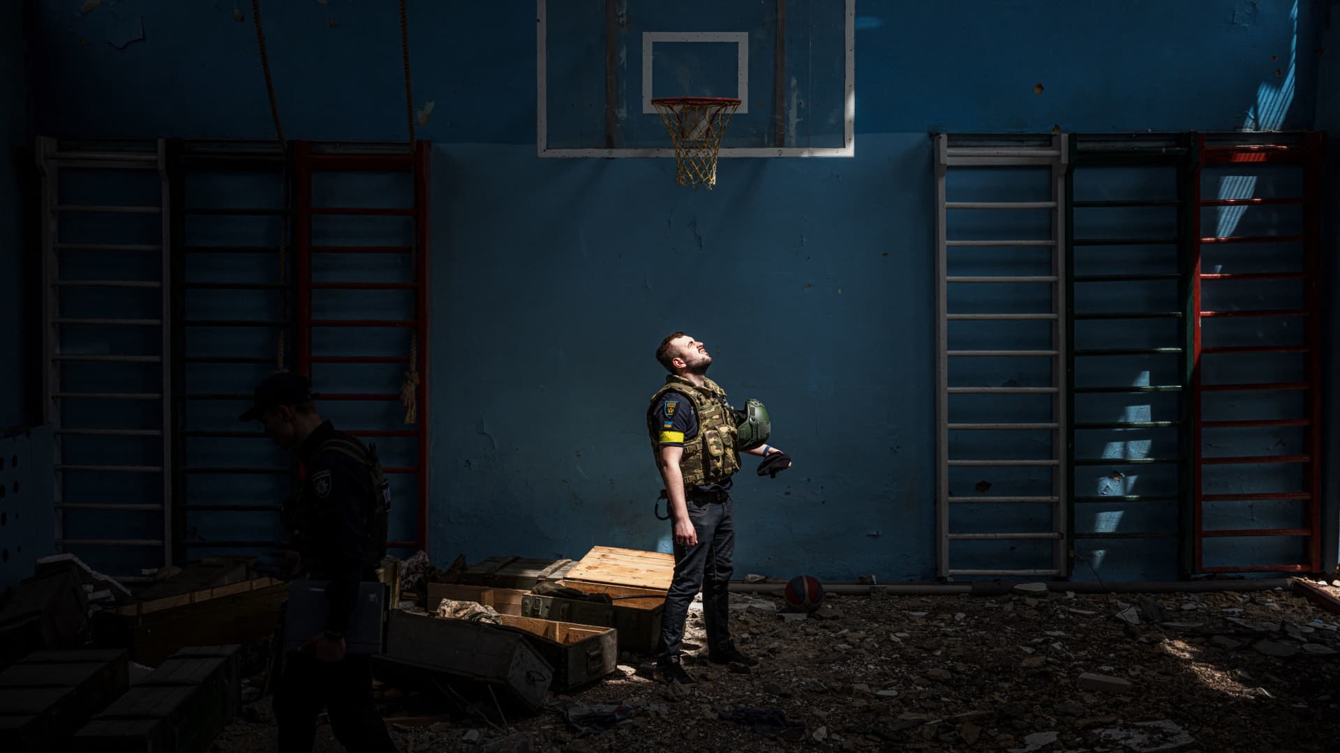 A police officer in a school gymnasium near Kharkiv, Ukraine, after the surrounding village was liberated by Ukrainian troops on May 13.