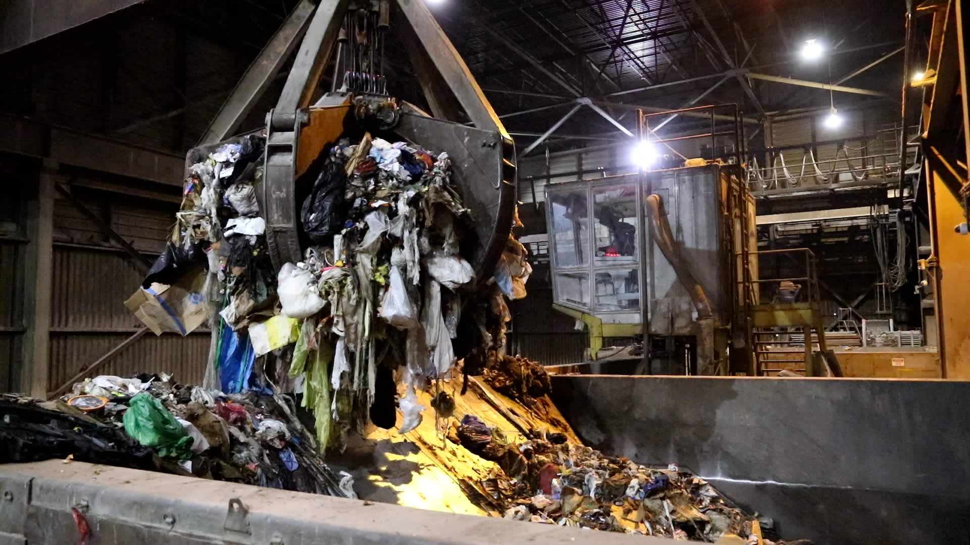 The claw picks up about seven tons of garbage and dumps it into the boiler, where it's burned to make energy at the Stanislaus County waste-to-energy plant on April 13, 2022.
