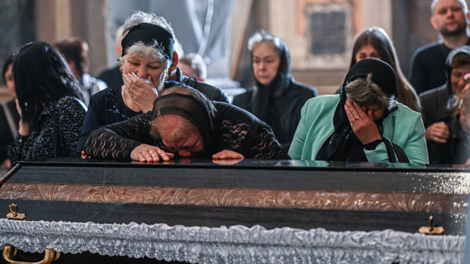 Relatives cry by the coffin of the Ukrainian fallen soldier Yurii Huk, age 41 at the Church of the Most Holy Apostles Peter and Paul in Lviv, Ukraine on May 16, 2022.