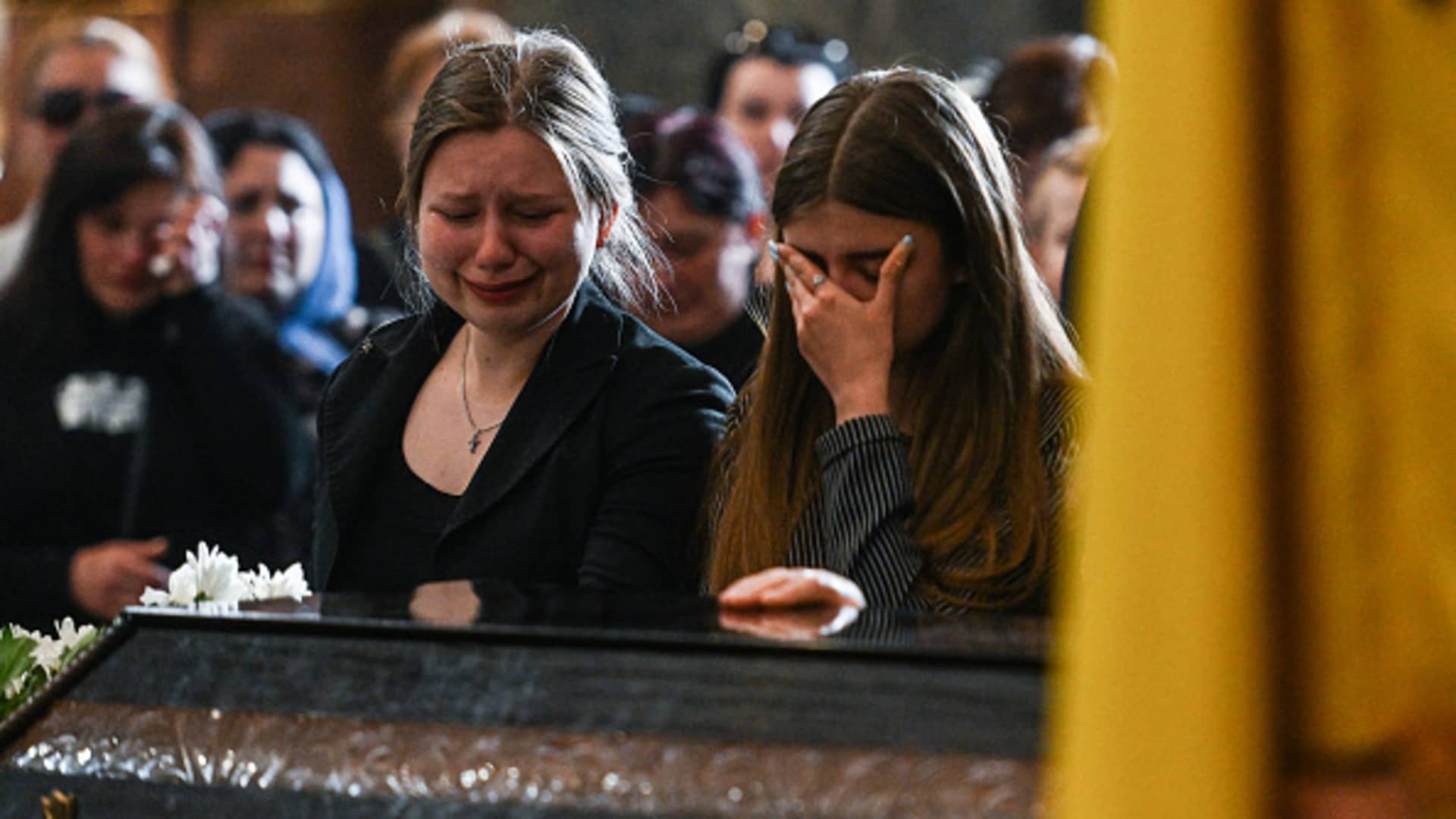 A relative of the Ukrainian fallen soldier Yurii Huk, age 41 cries and prays at the Church of the Most Holy Apostles Peter and Paul in Lviv, Ukraine on May 16, 2022.