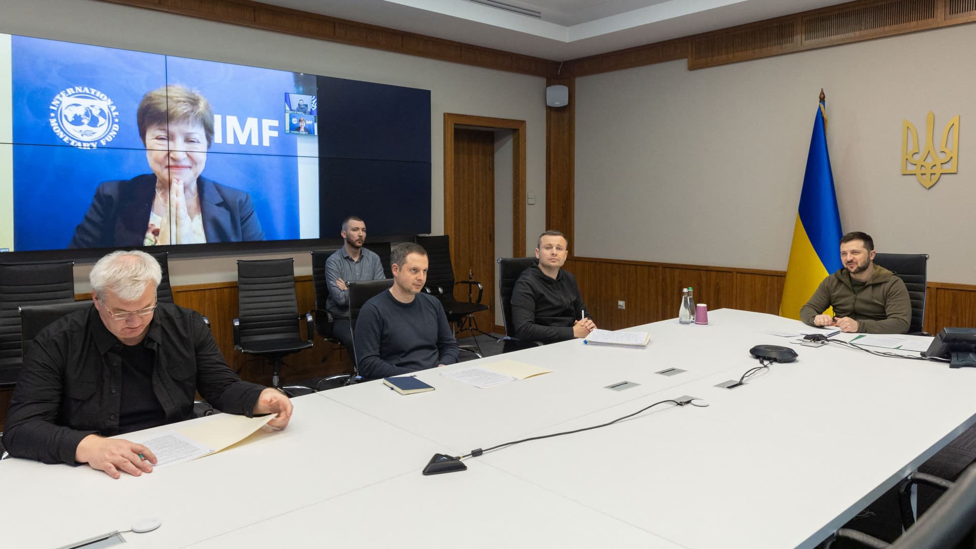 This handout picture taken and released by the Ukrainian President press-service in Kyiv on May 16, 2022 shows Ukrainian President Volodymyr Zelensky (R) and Managing Director of the International Monetary Fund (IMF) Kristalina Georgieva (on the screen) holding a video conference.