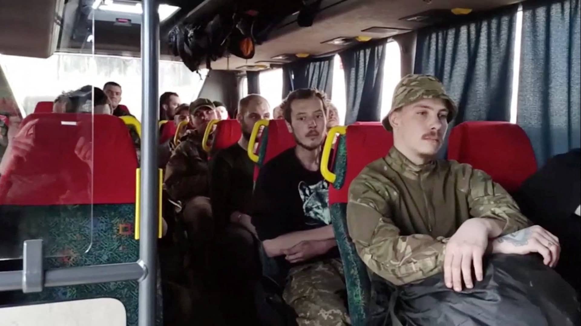 A still image taken from a video released by Russian Defence Ministry shows what it claims are service members of Ukrainian forces, who left the besieged Azovstal steel plant, sitting inside a bus in Mariupol, Ukraine. Video released May 17, 2022.