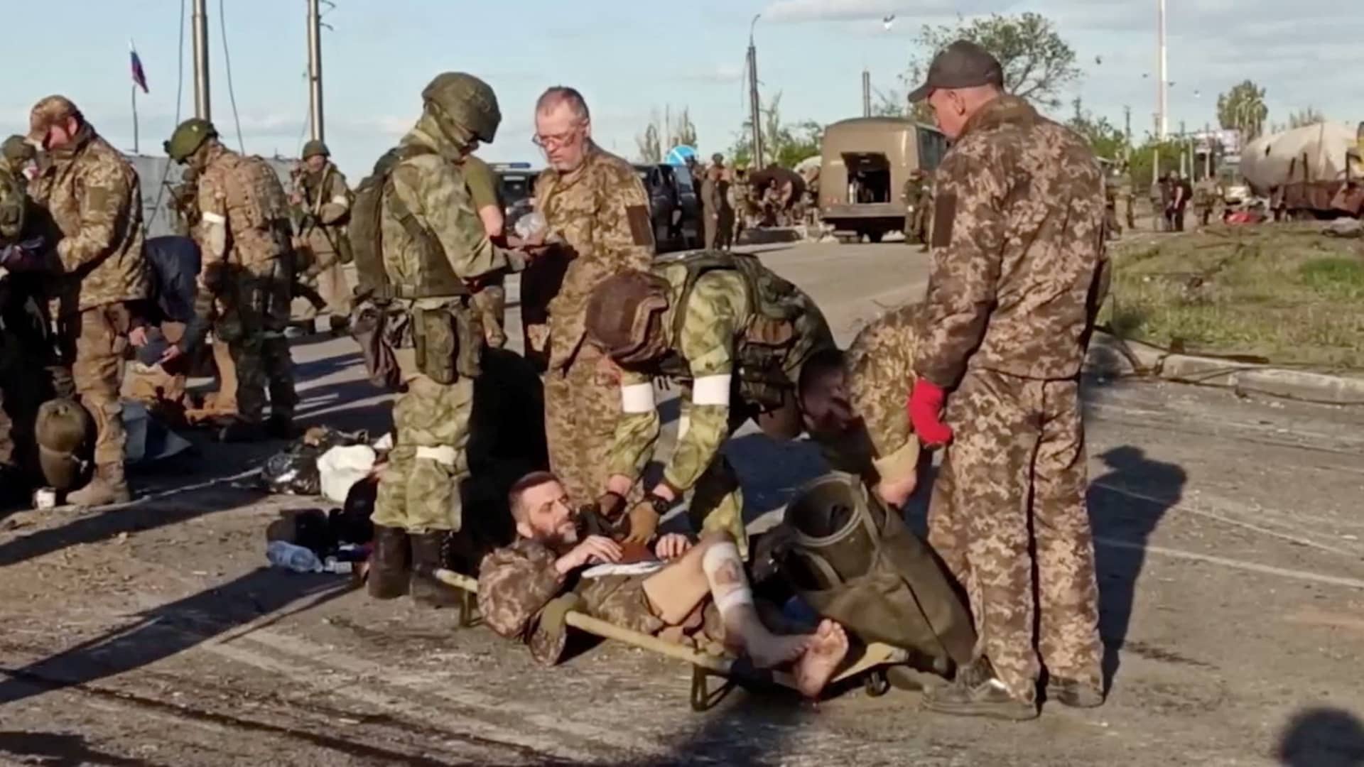 A still image taken from a video released by Russian Defence Ministry shows what it claims are service members of Ukrainian forces, who left the besieged Azovstal steel plant, being searched by the pro-Russian military in Mariupol, Ukraine. Video released May 17, 2022.