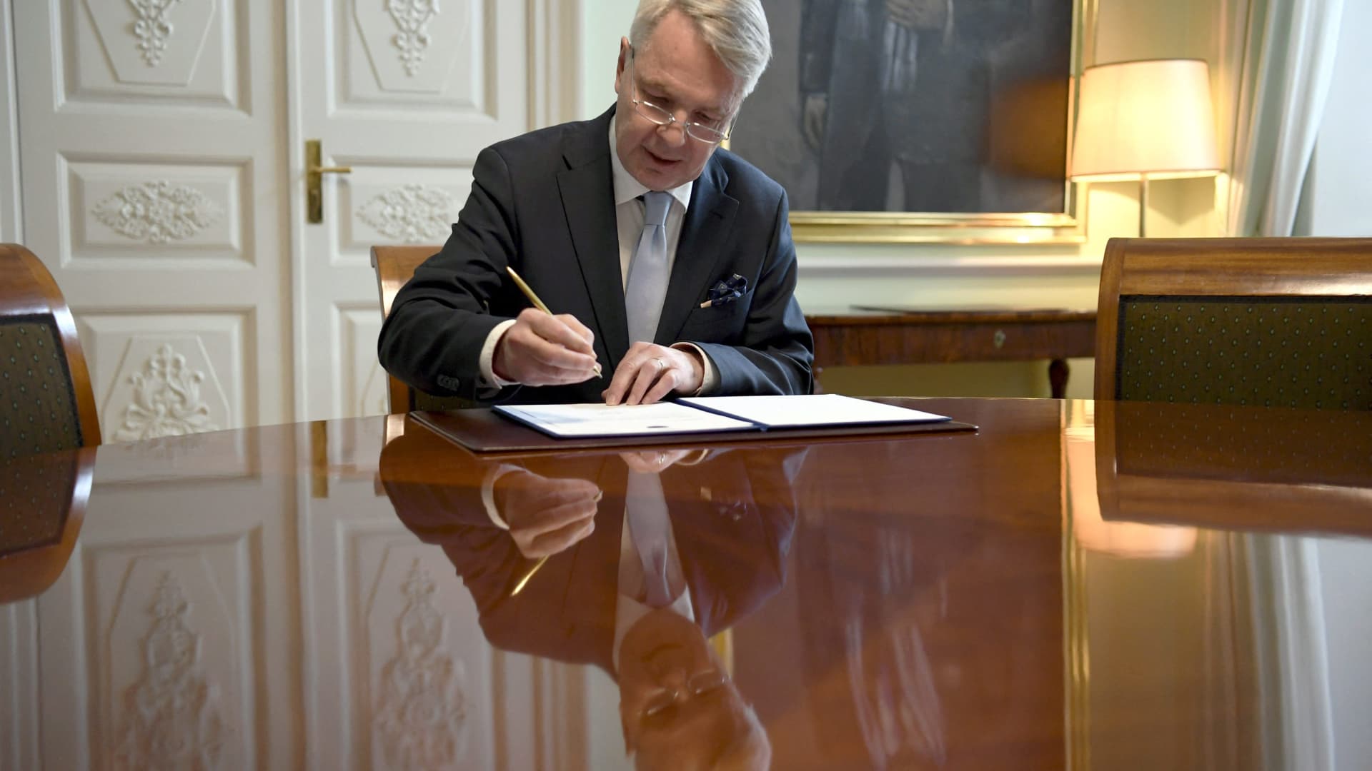 Finnish Foreign Minister Pekka Haavisto signs a petition for NATO membership in Helsinki on May 17, 2022. Turkish President Recep Tayyip Erdogan has said he opposes the Finland and Sweden joining NATO.