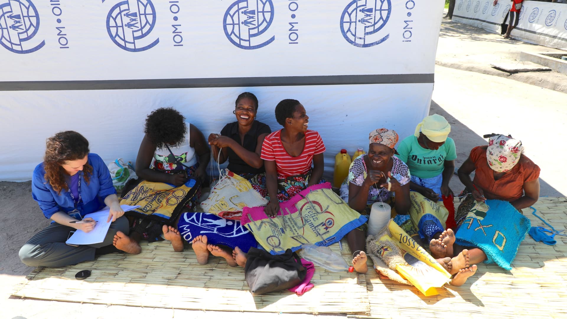 Sandra Black (left) with women participating in a carpet-making project in a resettlement site after Cyclone Idai hit Mozambique in 2019.