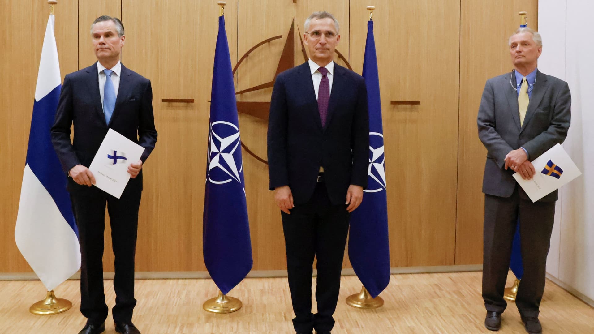 Finland's Ambassador to NATO Klaus Korhonen, NATO Secretary-General Jens Stoltenberg and Sweden's Ambassador to NATO Axel Wernhoff attend a ceremony to mark Sweden's and Finland's application for membership in Brussels, Belgium, May 18, 2022.