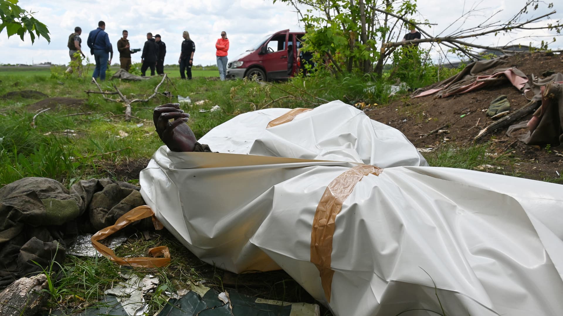 A picture shows a body bag as a Ukrainian police forensics team carry out the exhumation of bodies said to be Russian soldiers, outside the village of Mala Rogan, near Kharkiv, on May 18, 2022, amid Russia's military invasion launched on Ukraine.