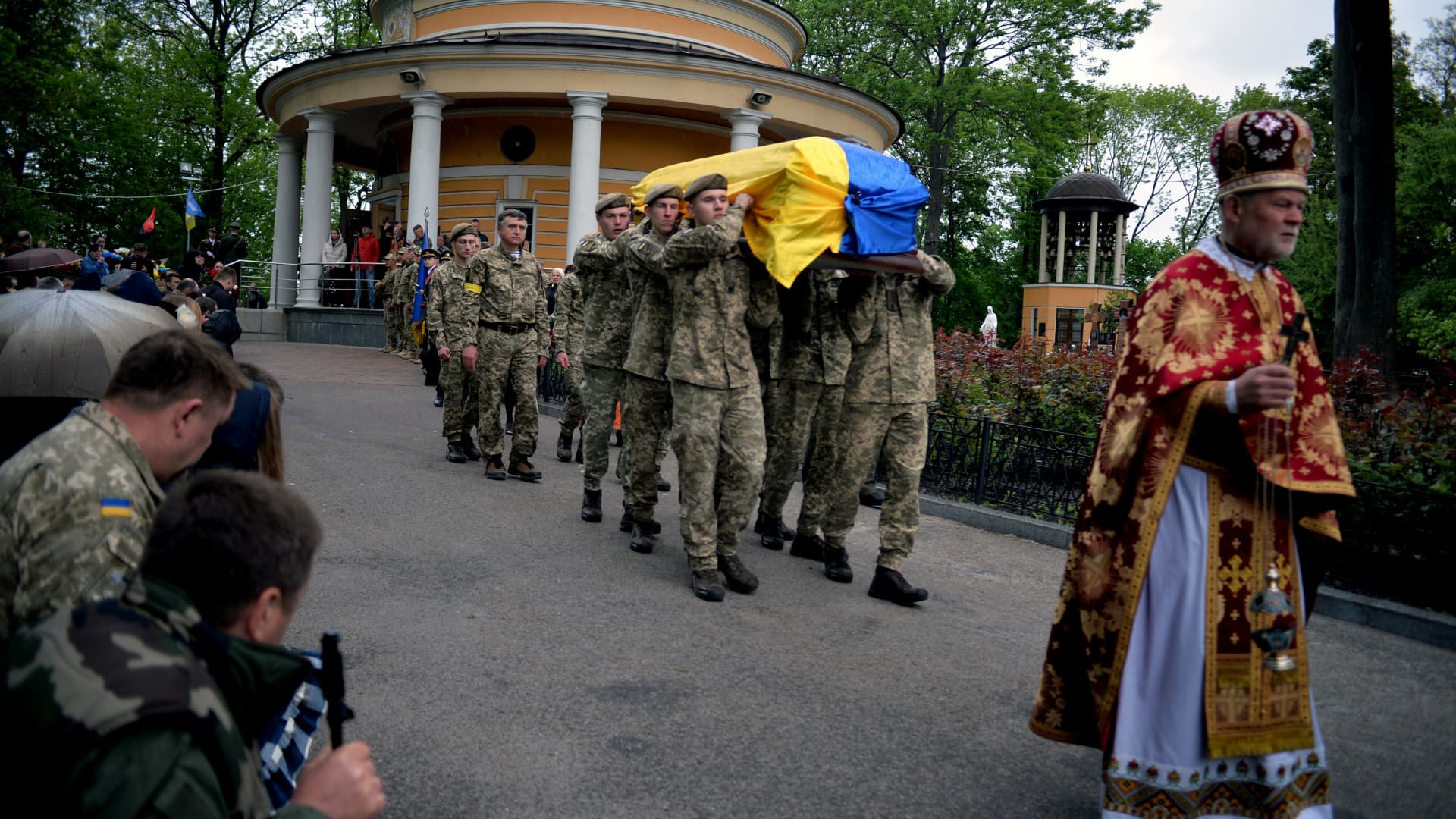 Servicemen carrying the coffin with the body of 95th Separate Air Assault Brigade officer, Lt Denys Antipov who perished while defending Ukraine's territorial integrity and independence from Russian invaders near Dovhenke village, Kharkiv Region, follow a priest outside St Nicholas' Church in Askold's Grave Park, Kyiv, capital of Ukraine.