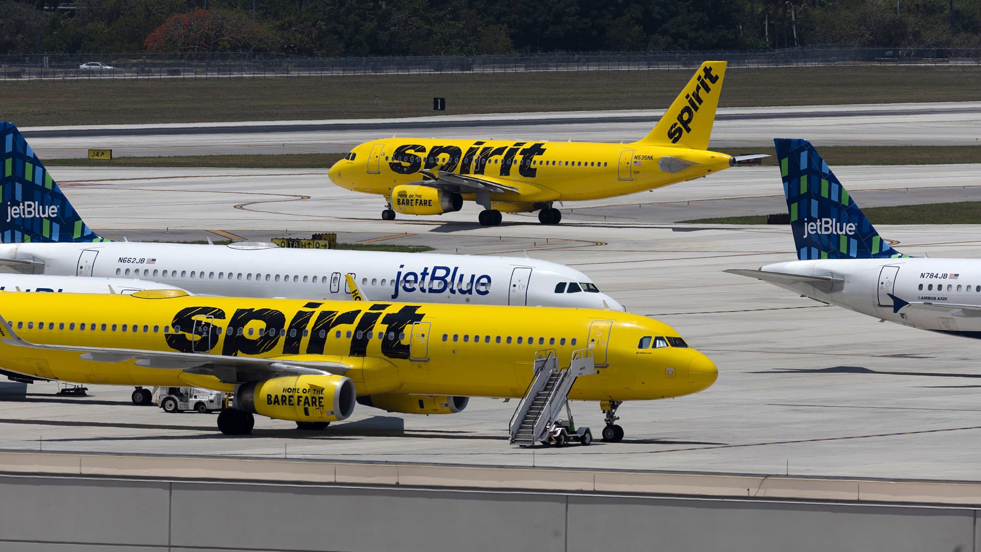 JetBlue Airlines planes are seen near Spirit Airlines planes at the Fort Lauderdale-Hollywood International Airport on May 16, 2022 in Fort Lauderdale, Florida.