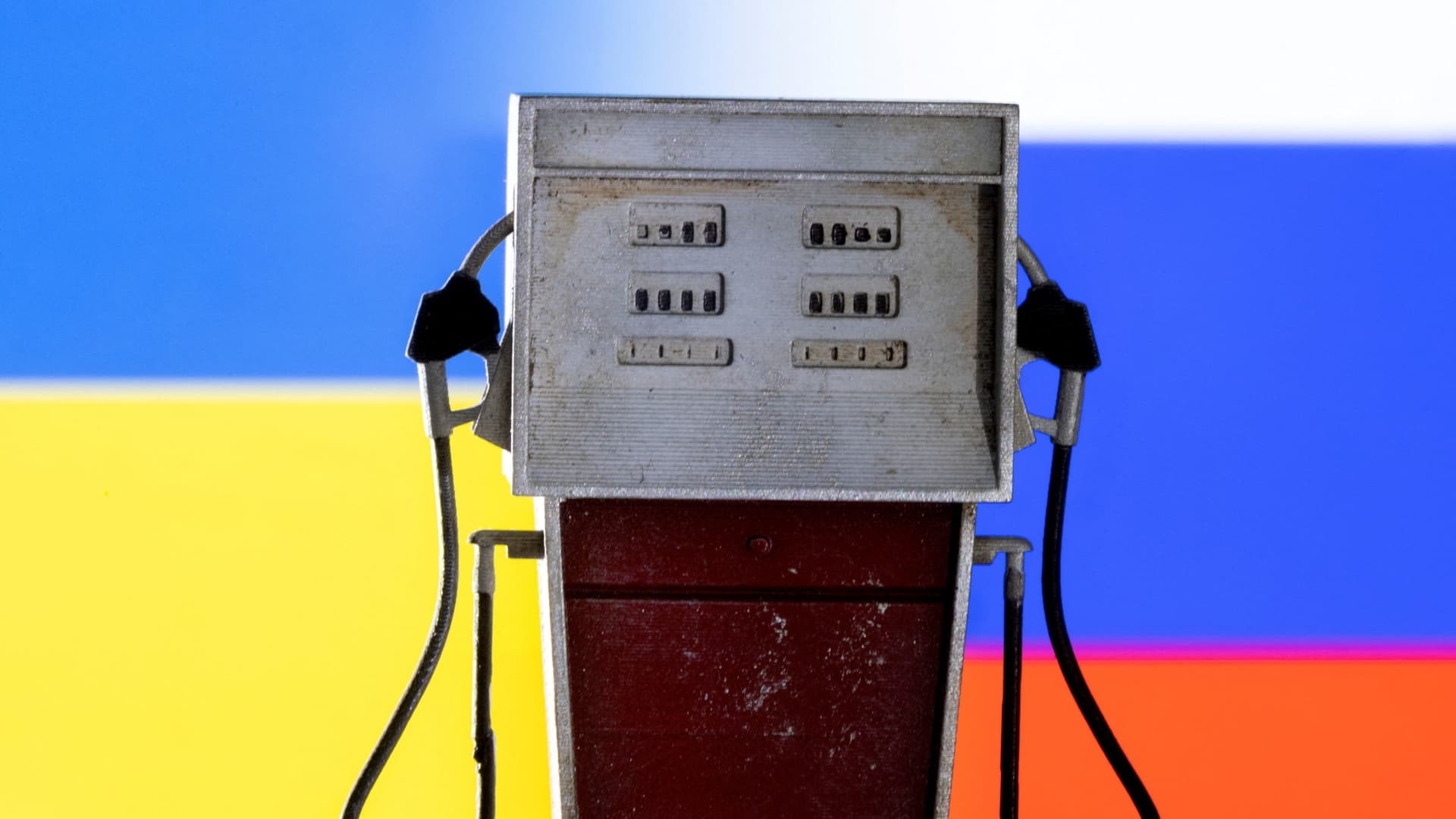 Model of petrol pump is seen in front of Ukraine and Russian flag colors in this illustration taken March 25, 2022. 