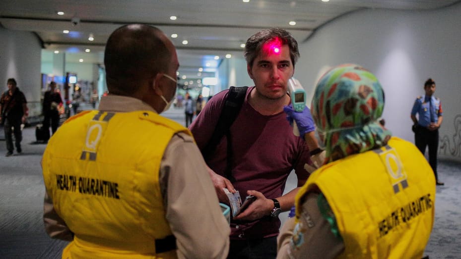 Health officer uses a thermal head to detect a monkeypox virus on arriving passengers at Soekarno-Hatta International Airport in Tangerang near Jakarta, Indonesia on May 15, 2019.