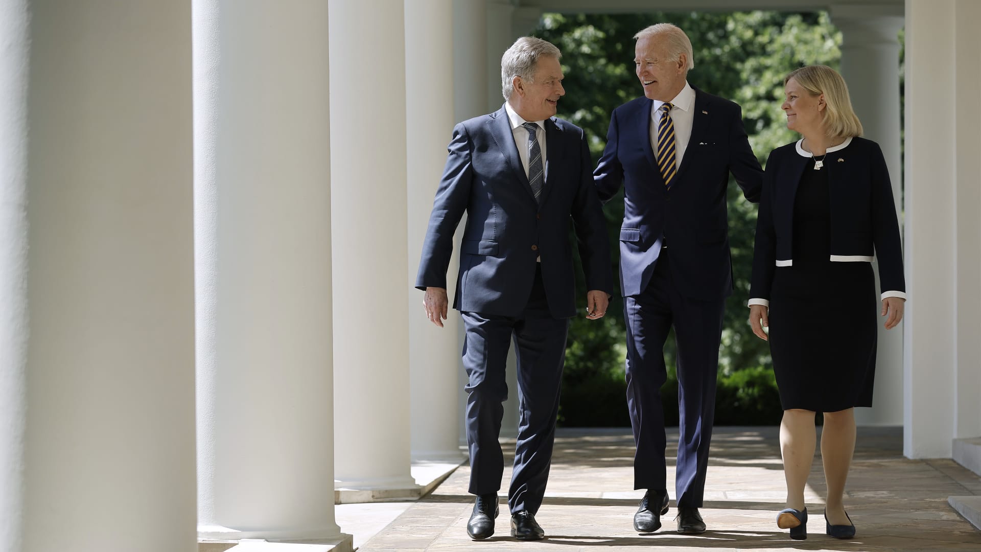 U.S. President Joe Biden walks with Finland's President Sauli Niinisto (left) and Sweden's Prime Minister Magdalena Andersson along the Rose Garden colonnade before making statements to the press at the White House on May 19, 2022.