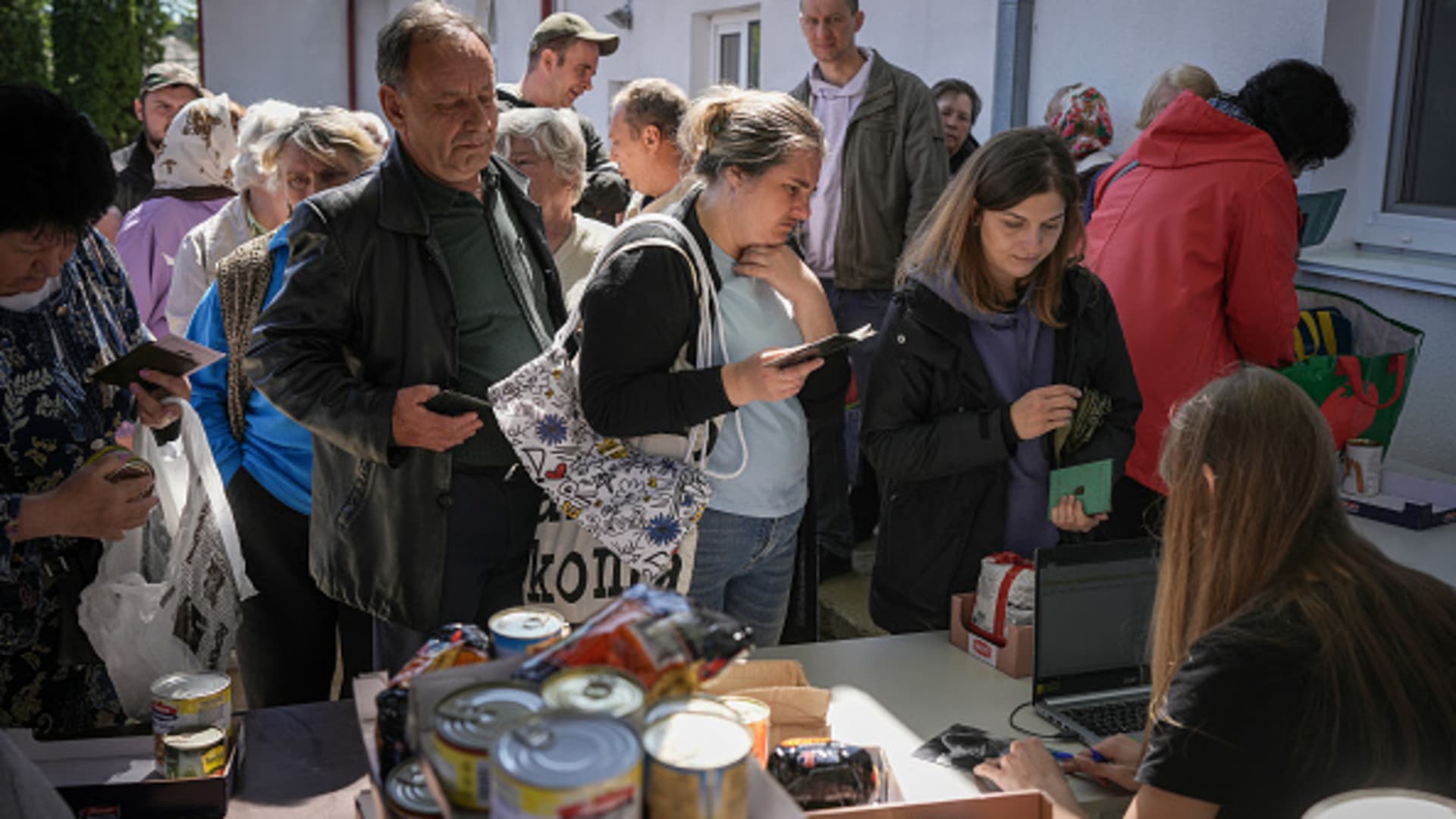 Residents of Irpin queue for charity food and essential items at the Irpin First Baptist Church on May 19, 2022, in Ukraine.