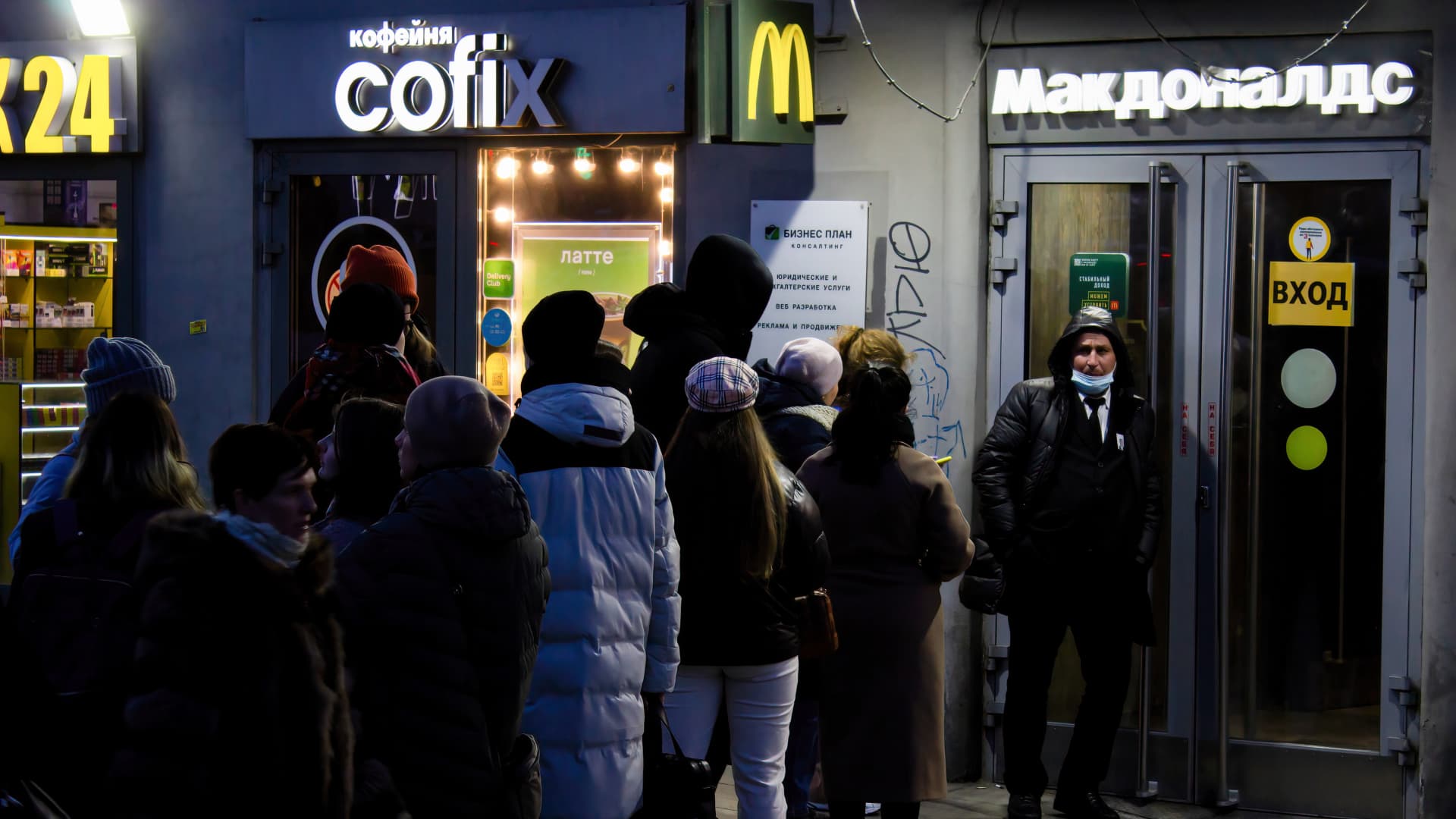People wait in line to enter a McDonald's restaurant in Moscow on March 11, 2022, after the chain announced it was temporarily closing its 850 restaurants in Russia, joining other foreign brands that have been suspending operations in Russia following the country's military campaign in neighboring Ukraine. McDonald's has since decided to exit Russia permanently.