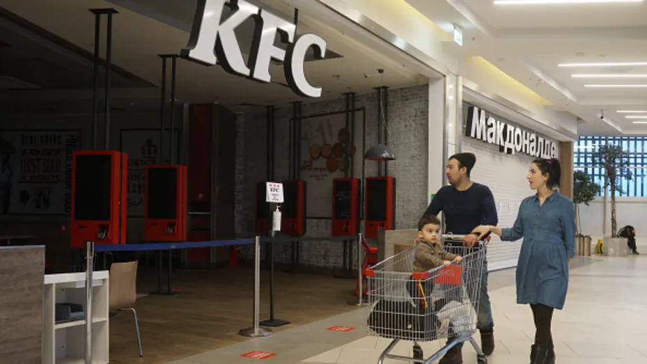 Shoppers look towards closed McDonald's and KFC restaurants at the Mega Mall, in Khimki, outside of Moscow, Russia on March 27, 2022.