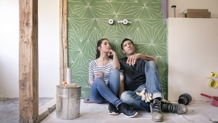 GP: Couple renovating new house, sitting on ground planning bathroom