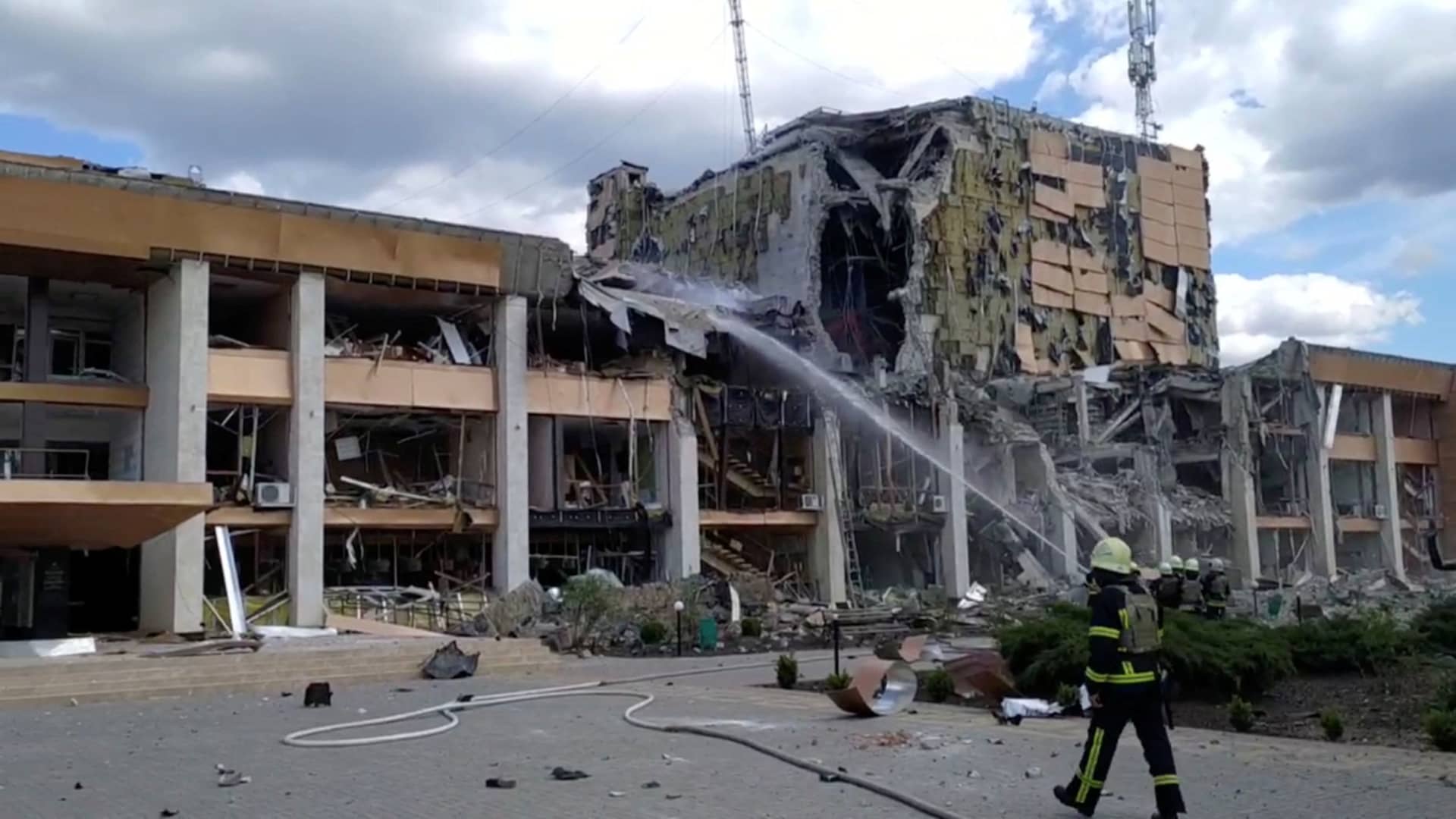 Firefighters work at the scene after an airstrike on the Cultural Centre, as Russia's attack on Ukraine continues, in Lozova, Kharkiv region, Ukraine in this still image taken from a handout video released May 20, 2022. 
