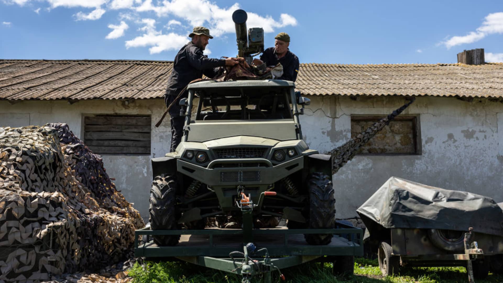 Soldiers put camouflage atop a weaponized Geon Strike 1000 ATV on May 20, 2022 in Kharkiv Oblast, Ukraine. T