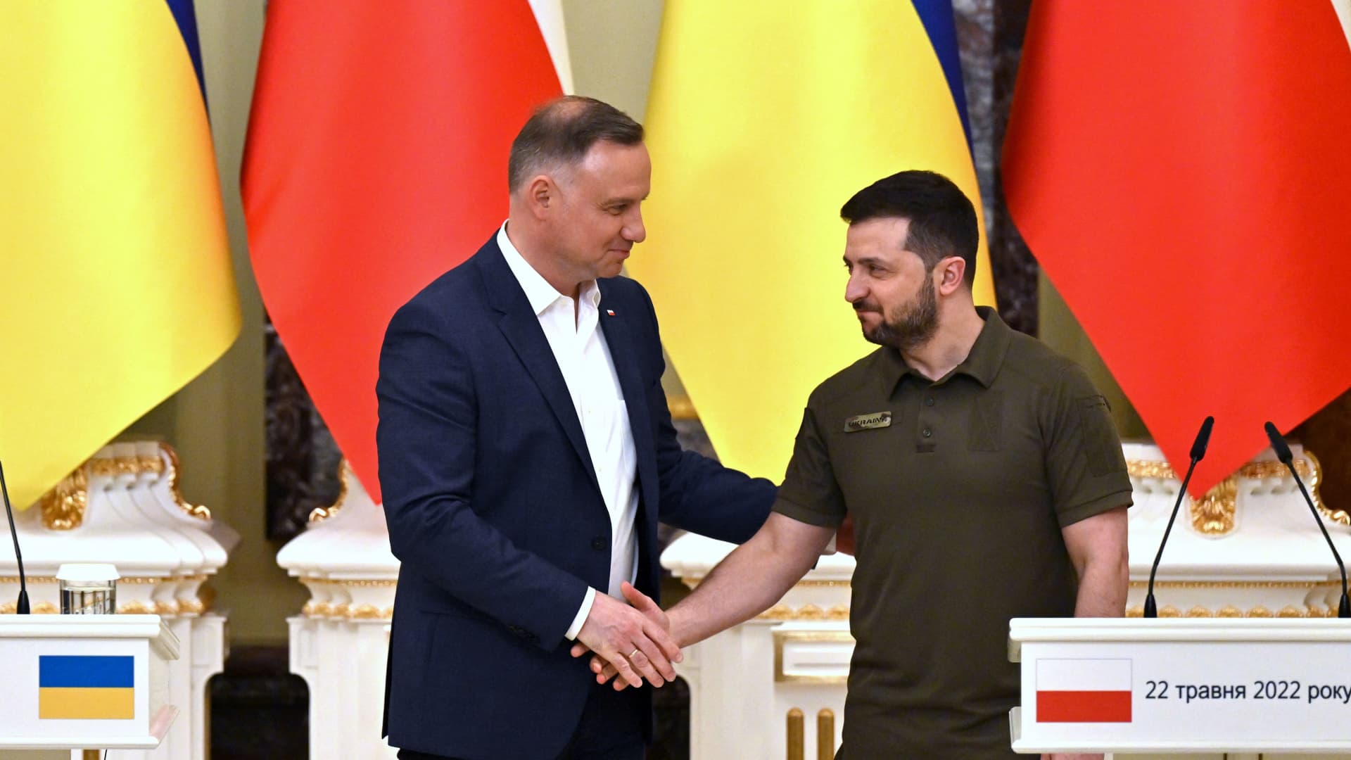 Ukrainian President Volodymyr Zelenskyy and his Polish counterpart Andrzej Duda shake hands during a press conference following their talks in Kyiv on May 22, 2022. Ukraine and Poland have agreed to work on joint border controls as well as a shared railway company to relieve the movement of people and grow Ukraine's export potential, Reuters reported.