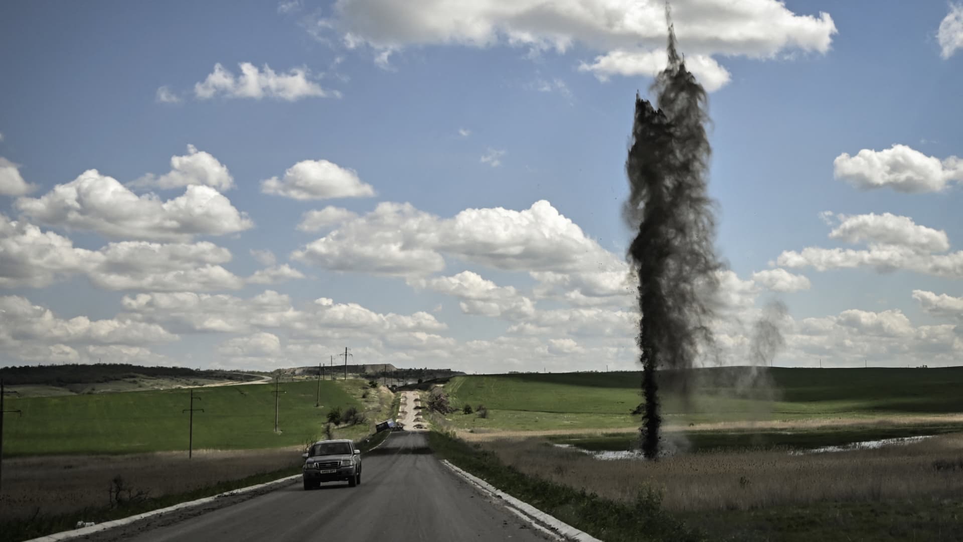 A mortar explodes next to the road leading to the city of Lysychansk in the eastern Ukranian region of Donbas, on May 23, 2022, amid Russian invasion of Ukraine.