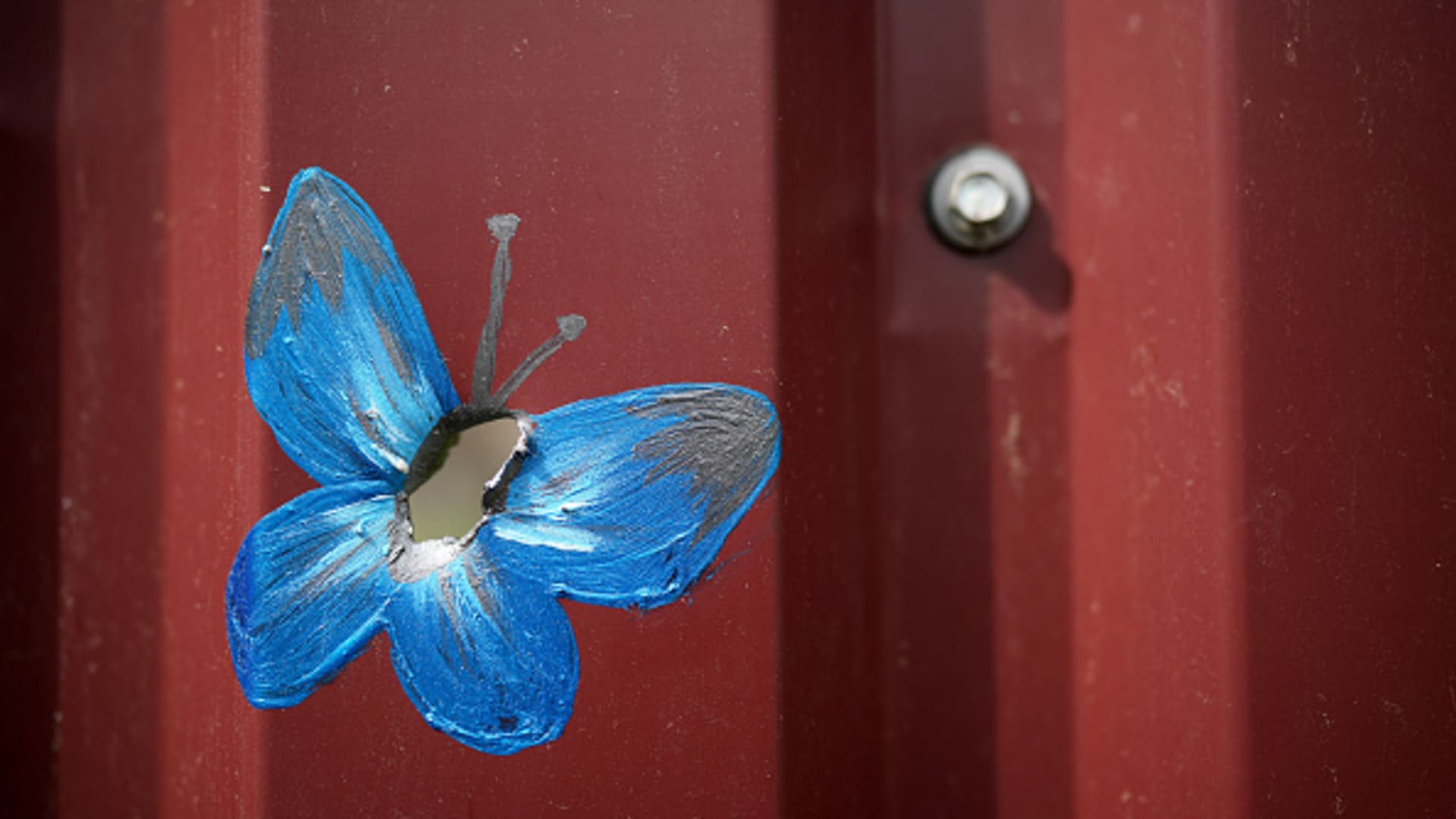 A butterfly painted around bullet and shrapnel holes by Canadian artist Ivanka Siolkowsky in the war torn suburb of Bucha on May 23, 2022 in Bucha, Ukraine. 