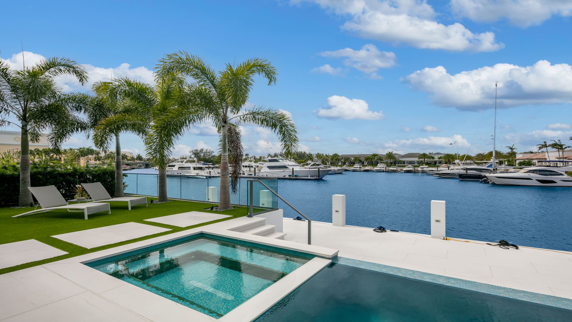 The pool and hot tub situated above the home's dock and overlook the community's marina.