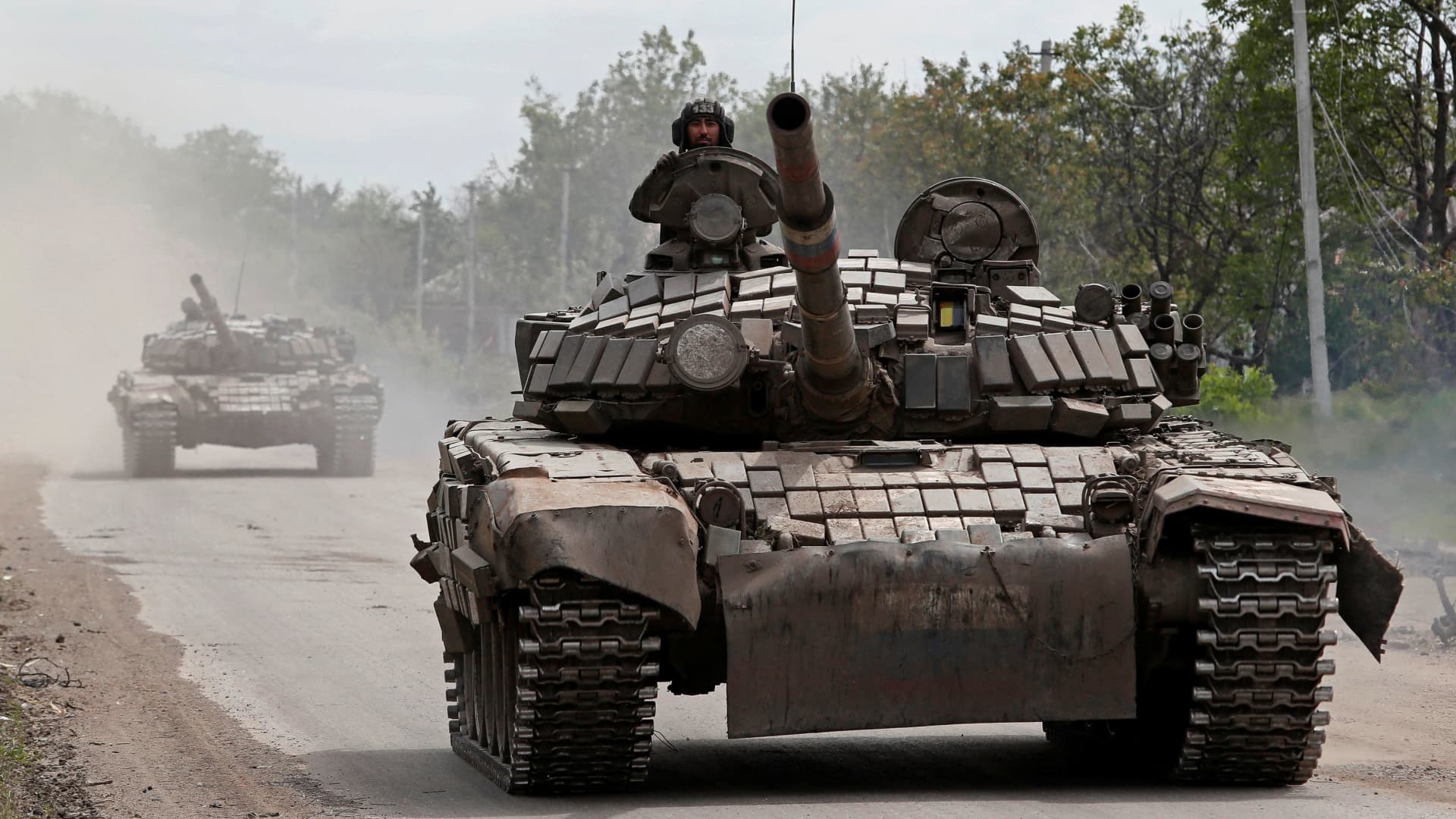 Tanks of pro-Russian troops drive along a street in the town of Popasna in the Luhansk region of Ukraine on May 26, 2022.