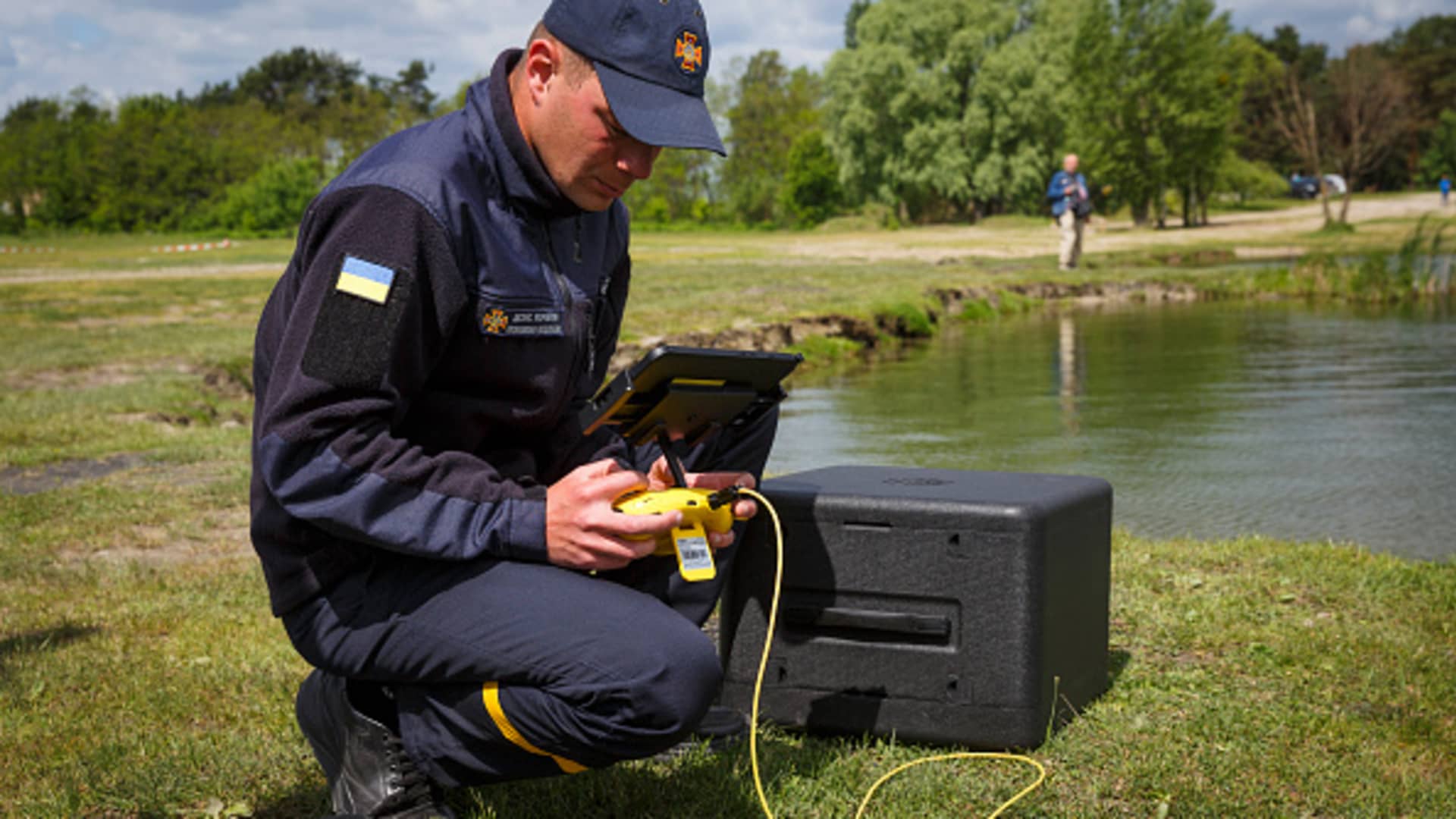 An employee of the State Emergency Service of Ukraine is inspecting the lake with the help of a drone in Kyiv, Ukraine on May 27, 2022.