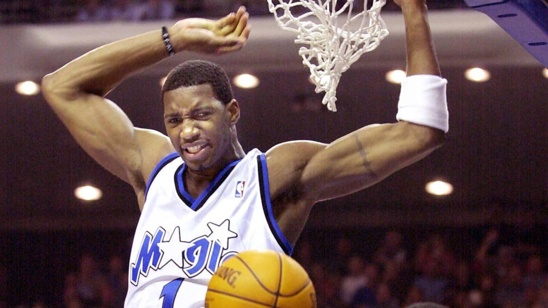 Orlando Magic guard Tracy McGrady (1) slam dunks the ball past Washington Wizards' guard Rod Strickland during the second period of the game at the TD Waterhouse Centre in Orlando, 31, October 2000.