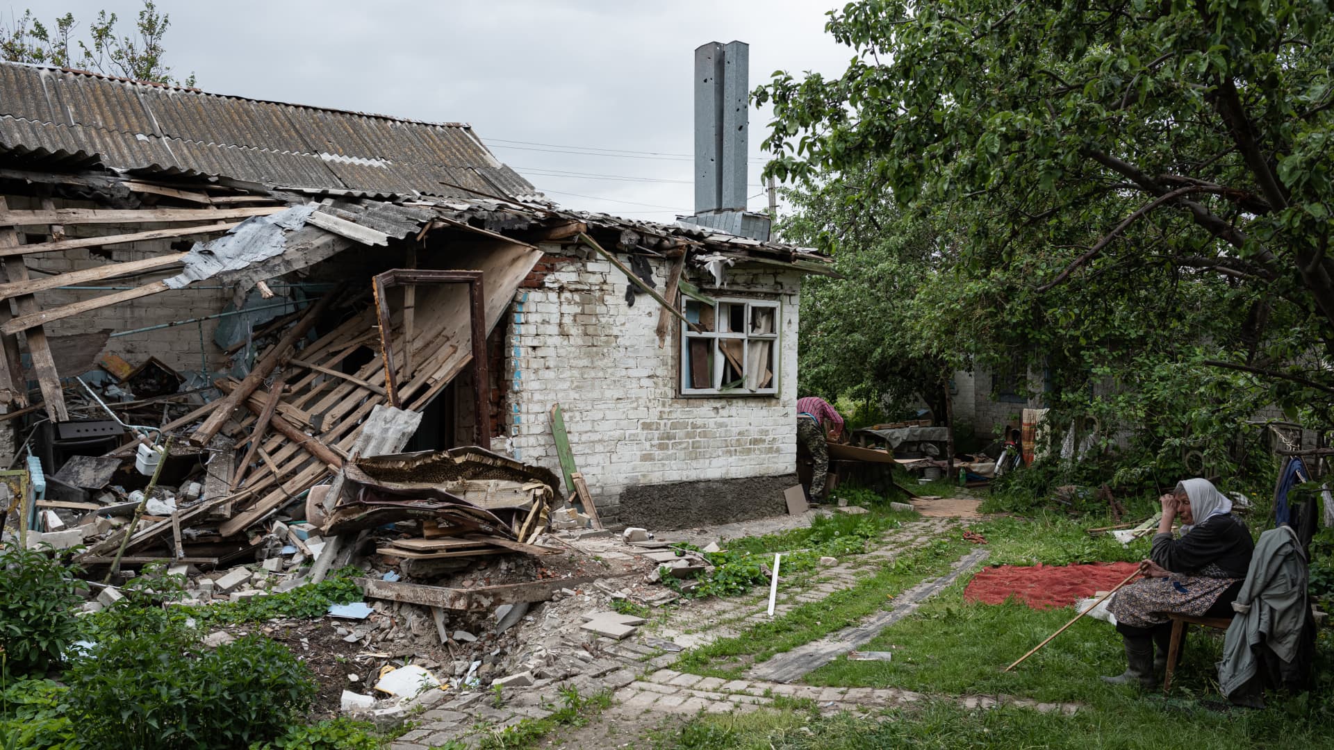Nadiia, 75, cries next to her heavily damaged house on May 27, 2022 in Chernihiv, Ukraine. Chernihiv, northeast of Kyiv, was an early target of Russia's offensive after its Feb. 24 invasion.
