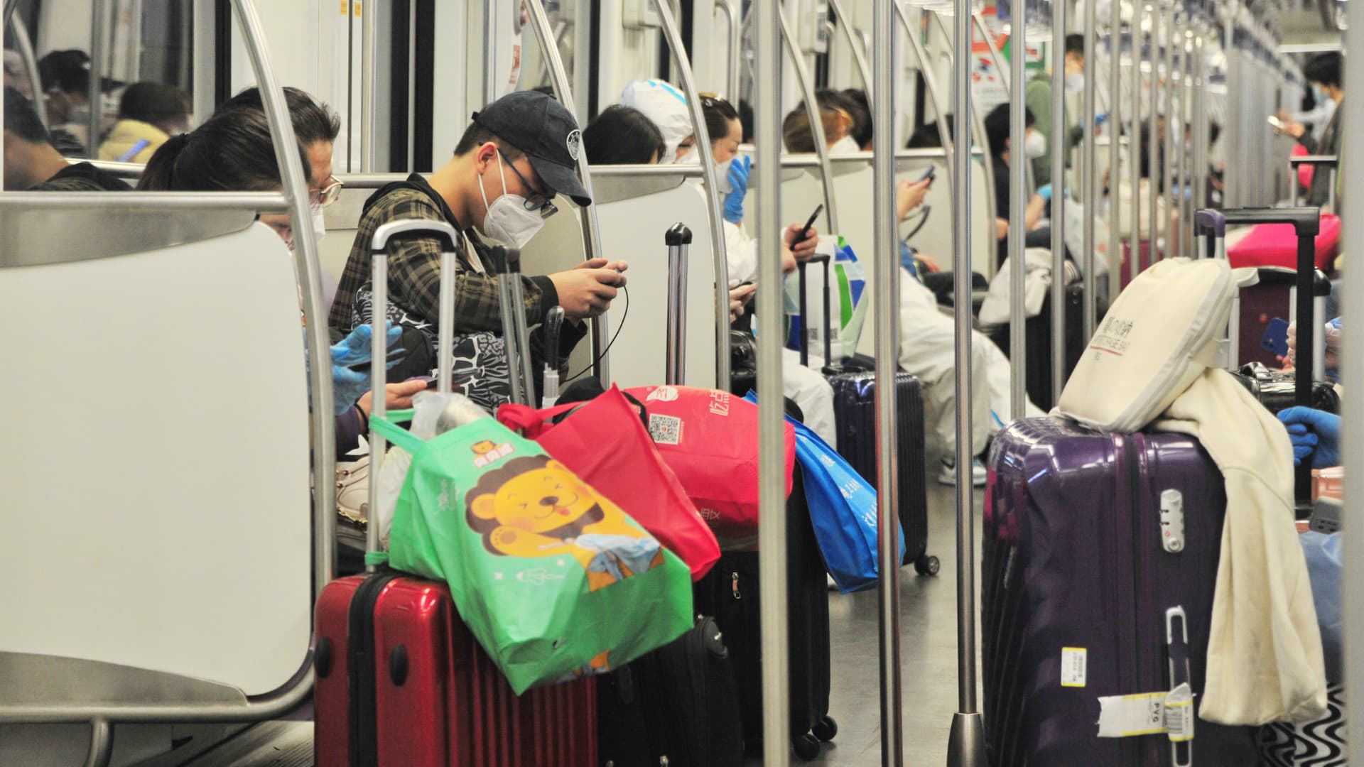 After about two months of lockdown, Shanghai announced plans over the weekend to relax restrictions on business activity. Subway riders pictured here on May 28, 2022, ride on one of four lines in the city that have resumed operations.